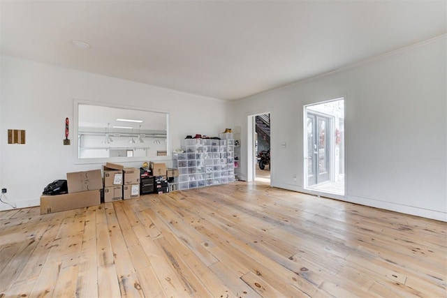 unfurnished living room with crown molding and hardwood / wood-style flooring