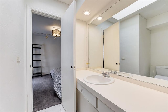 bathroom featuring toilet and vanity