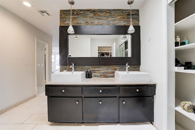 full bath with double vanity, tasteful backsplash, visible vents, and a sink