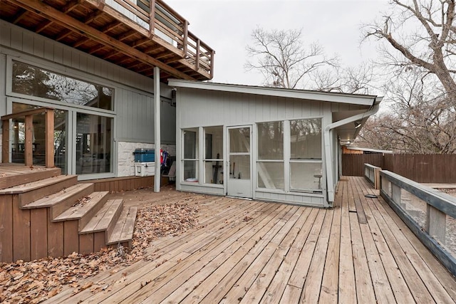 deck featuring fence and a sunroom