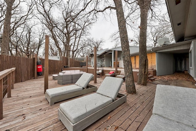 deck featuring cooling unit, an outdoor hangout area, and fence