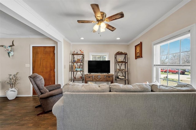 living room featuring crown molding, baseboards, dark wood-type flooring, and ceiling fan