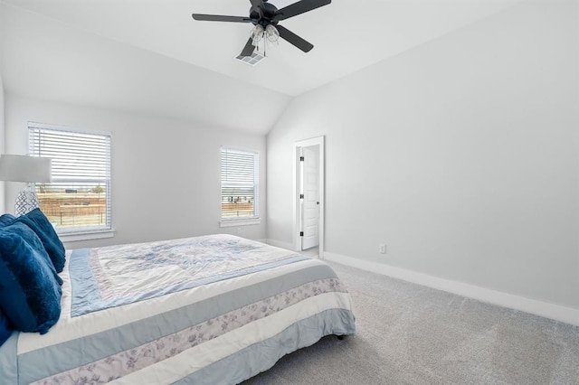 carpeted bedroom featuring lofted ceiling, visible vents, baseboards, and ceiling fan