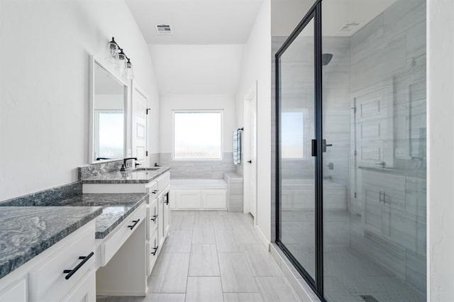 bathroom with vanity, a garden tub, visible vents, and a stall shower