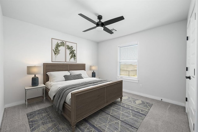 carpeted bedroom with visible vents, baseboards, and ceiling fan