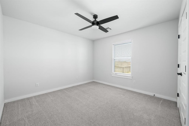 unfurnished room featuring visible vents, baseboards, carpet, and a ceiling fan