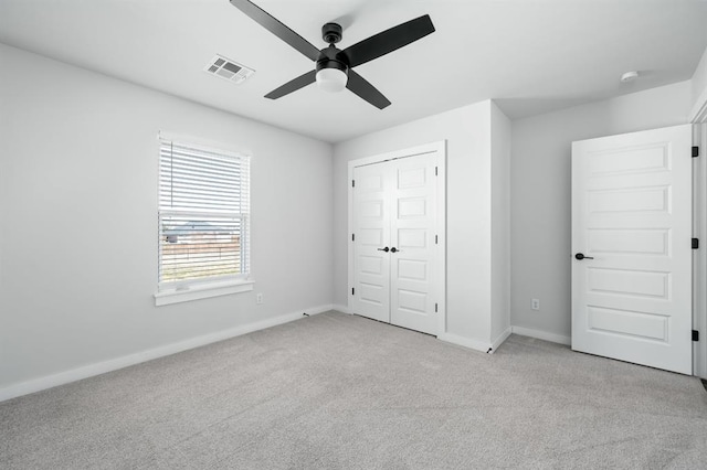 unfurnished bedroom with visible vents, baseboards, carpet, and a closet