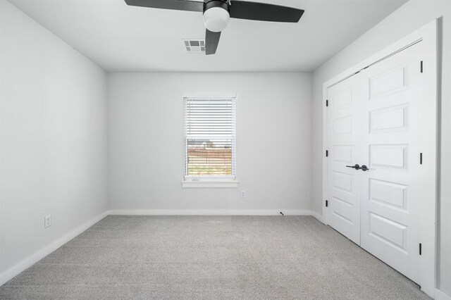 unfurnished bedroom featuring a ceiling fan, baseboards, visible vents, carpet floors, and a closet