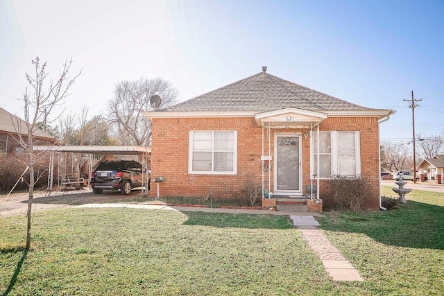 bungalow-style home featuring brick siding, a front yard, and a shingled roof