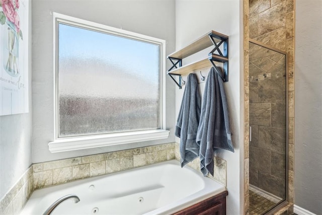 bathroom with a jetted tub and a shower stall