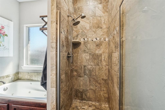 bathroom with a stall shower and a jetted tub