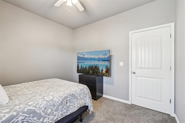 carpeted bedroom featuring a ceiling fan and baseboards