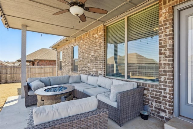 view of patio with an outdoor living space with a fire pit, a ceiling fan, and fence