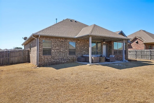 rear view of house with brick siding, ceiling fan, outdoor lounge area, a fenced backyard, and a patio area