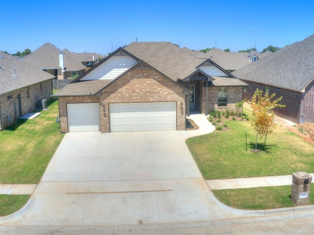 view of front of home with a front lawn, an attached garage, and a shingled roof