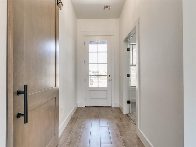 entryway with visible vents, baseboards, and light wood-style floors