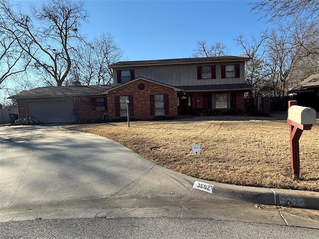 traditional-style house with brick siding, concrete driveway, an attached garage, and fence