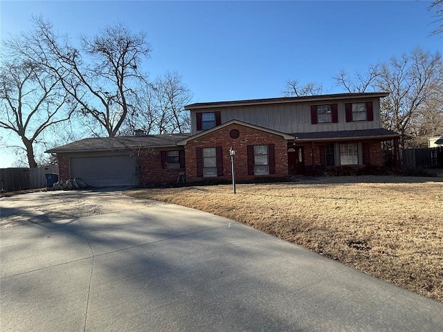 traditional-style house with driveway, brick siding, an attached garage, and fence