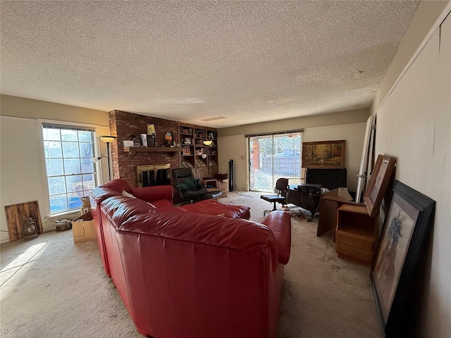 living room featuring light colored carpet, a fireplace, and a textured ceiling