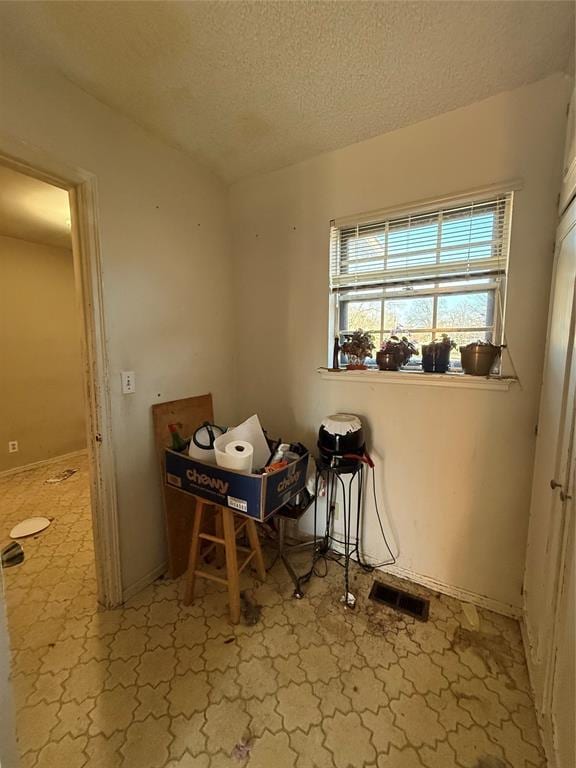 interior space with visible vents and a textured ceiling