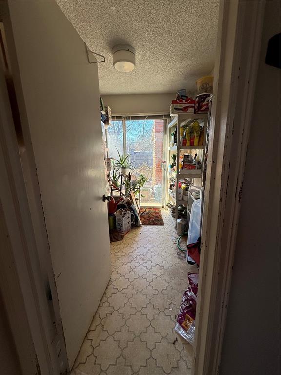 corridor with a textured ceiling