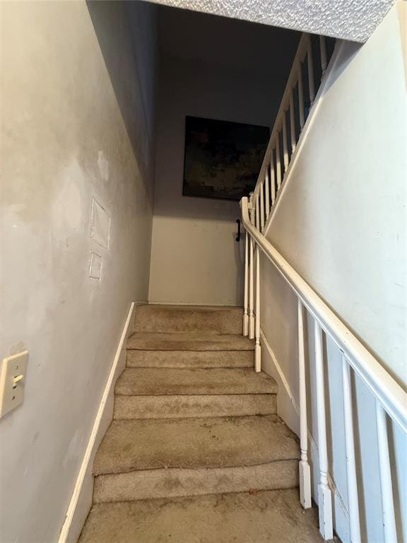 stairway featuring baseboards