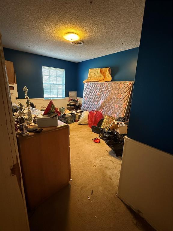 carpeted bedroom with a textured ceiling