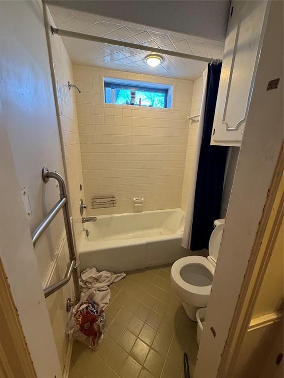 full bath with tile patterned floors, shower / bathtub combination with curtain, and toilet