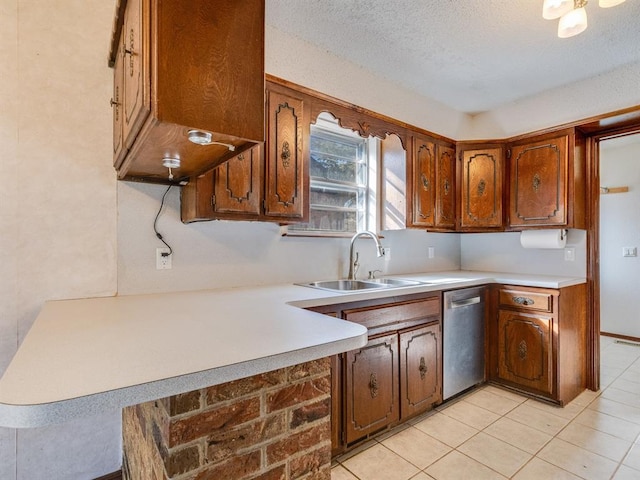 kitchen with a sink, dishwasher, brown cabinetry, and light countertops