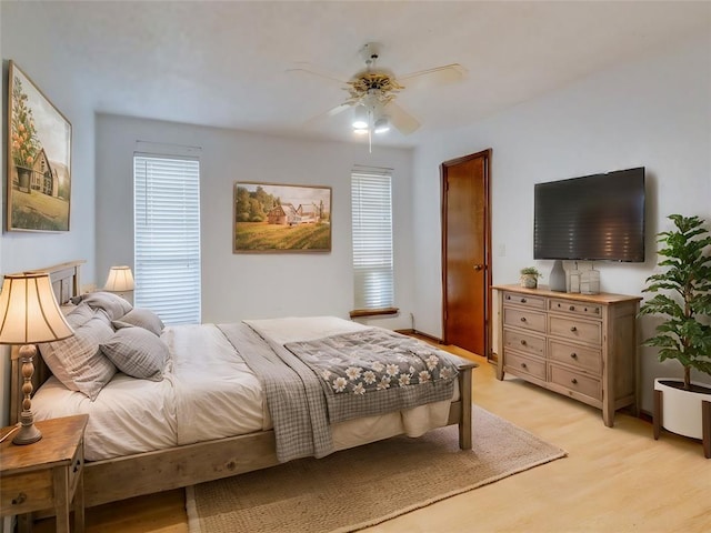 bedroom with multiple windows and a ceiling fan