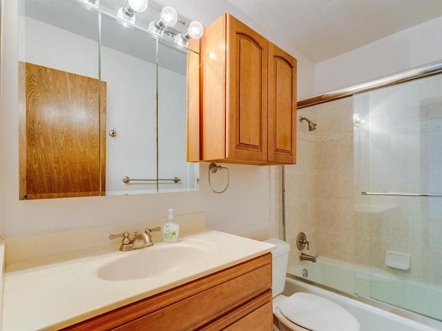 full bathroom featuring bath / shower combo with glass door, toilet, and vanity