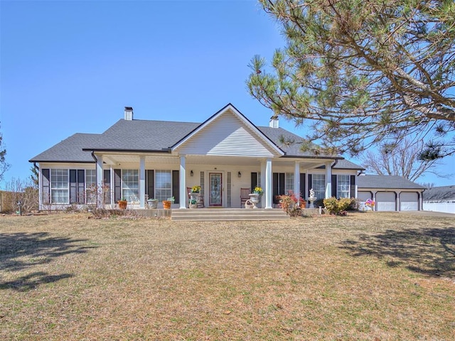 view of front facade featuring a front lawn, covered porch, and a garage