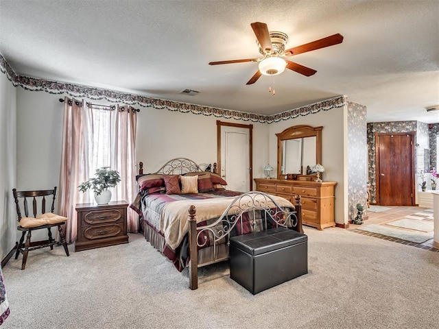 bedroom with baseboards, visible vents, a closet, a textured ceiling, and carpet flooring