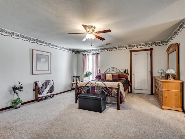 bedroom featuring a textured ceiling, ceiling fan, baseboards, and light carpet