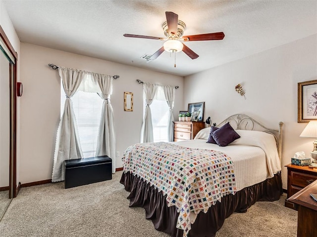 bedroom featuring carpet flooring, a ceiling fan, a closet, and baseboards