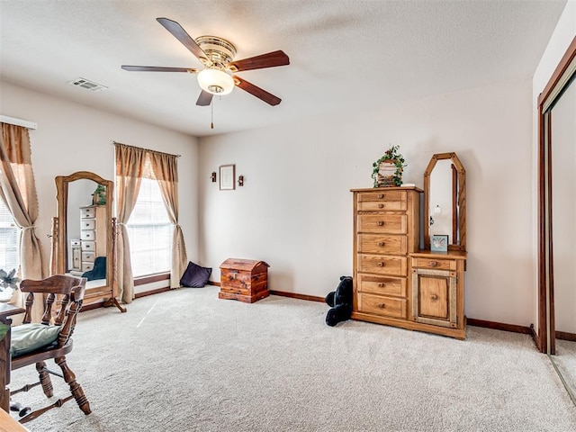 interior space with visible vents, light carpet, a textured ceiling, and baseboards