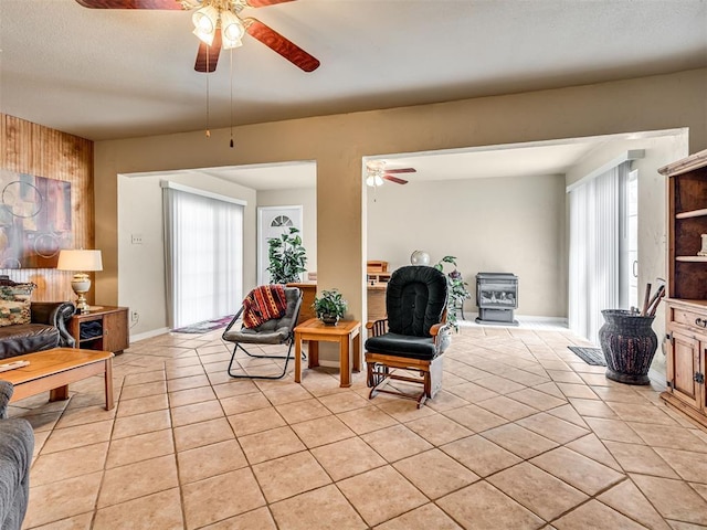 living area featuring light tile patterned floors, a healthy amount of sunlight, a textured ceiling, and a ceiling fan