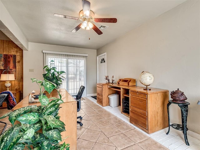 office space with visible vents, baseboards, light tile patterned floors, a textured ceiling, and a ceiling fan