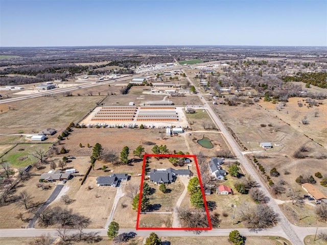 birds eye view of property with a rural view