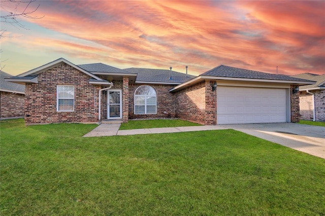 ranch-style home with brick siding, an attached garage, a front yard, roof with shingles, and driveway