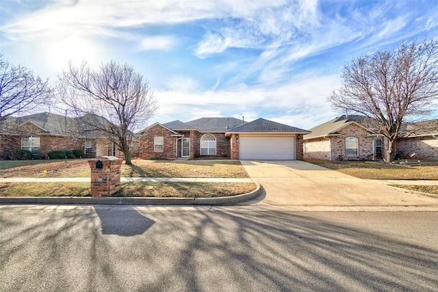 ranch-style home featuring concrete driveway, an attached garage, and brick siding