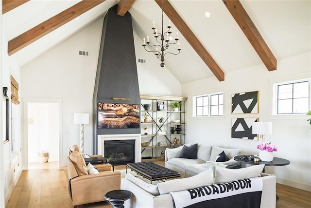 living room featuring a healthy amount of sunlight, visible vents, and high vaulted ceiling