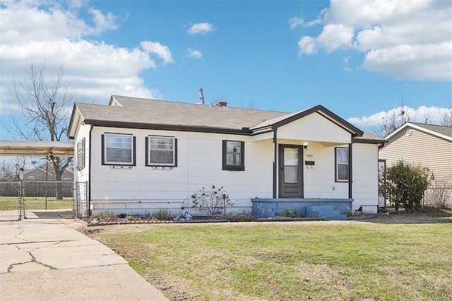 bungalow-style house featuring a carport, fence, a front yard, and driveway