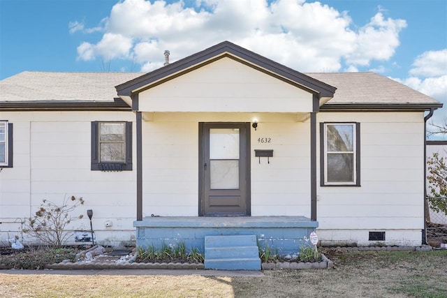 bungalow-style home with crawl space and a shingled roof