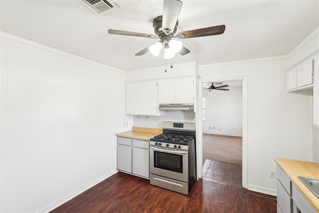 kitchen with light countertops, crown molding, gas stove, and visible vents