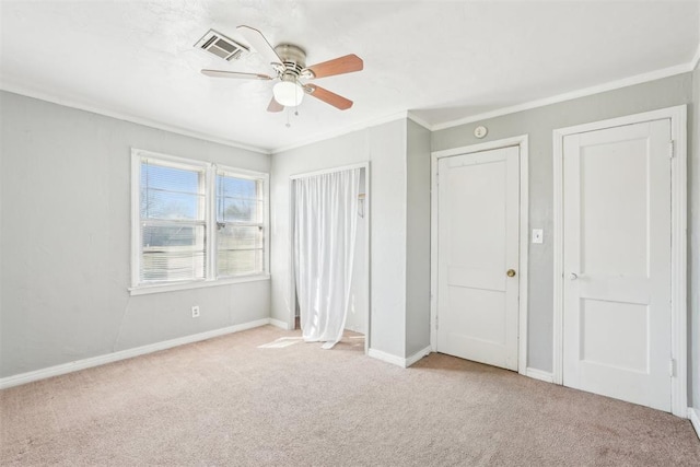 unfurnished bedroom with baseboards, carpet, visible vents, and ornamental molding