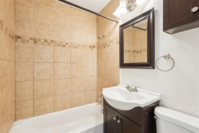 bathroom with tub / shower combination, toilet, and vanity