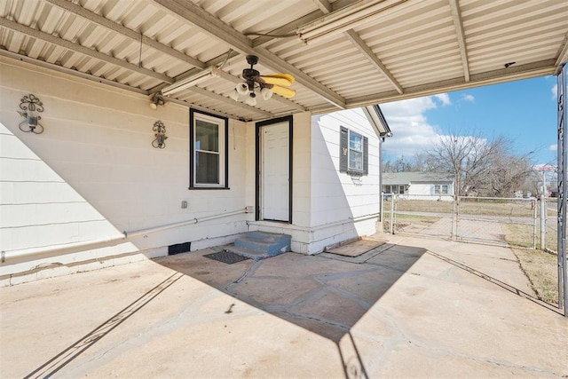 view of patio / terrace featuring entry steps, fence, a ceiling fan, and a gate