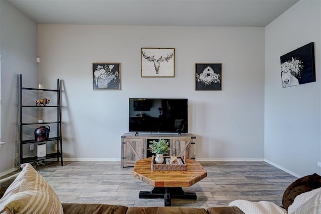 living room with wood finished floors and baseboards