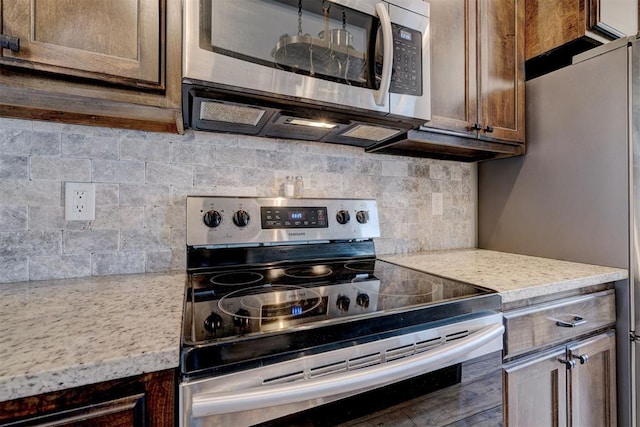 kitchen featuring backsplash, stainless steel appliances, and light countertops